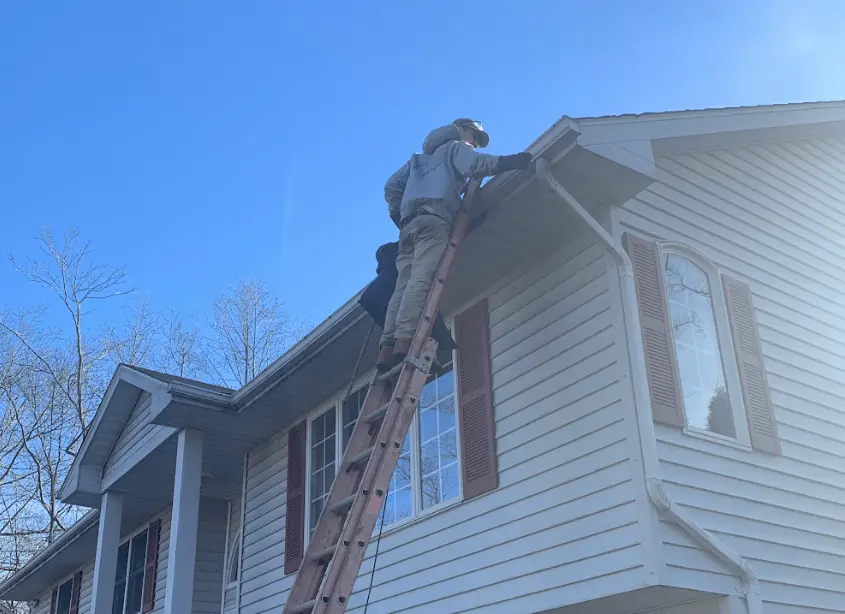 Gutter cleaning and maintenance being performed by East Cleveland Power Washing in East Cleveland